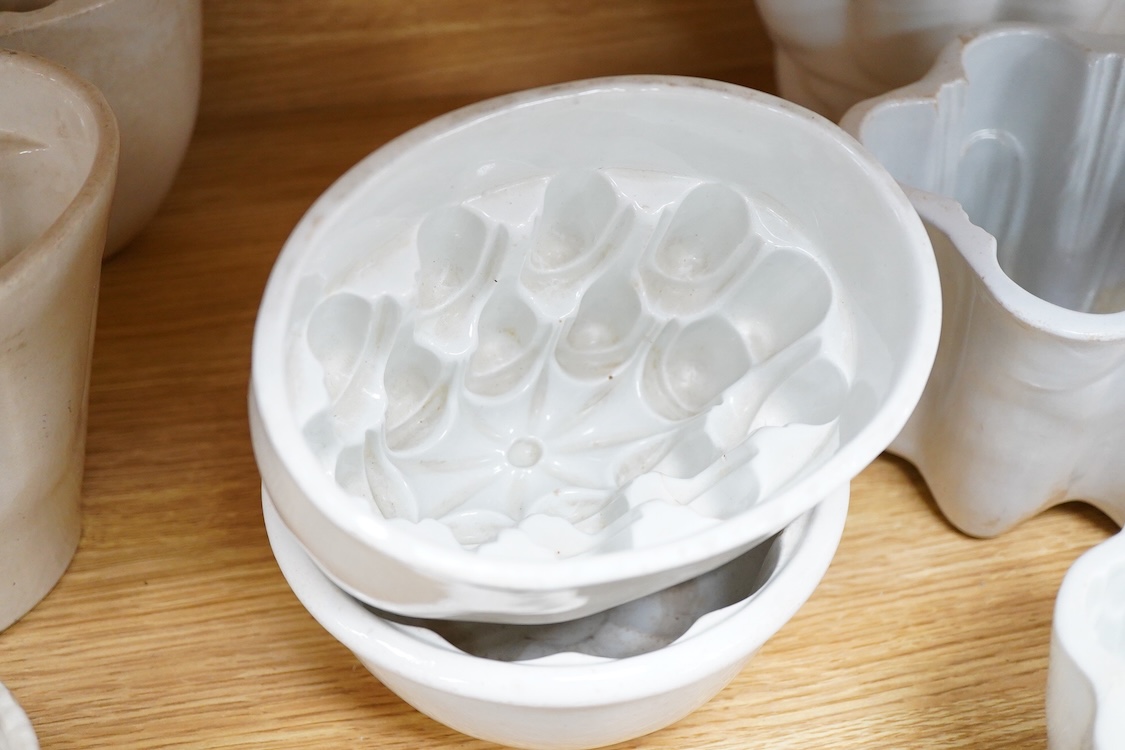 A collection of fifteen mostly 20th century ceramic jelly moulds, largest 16cm high